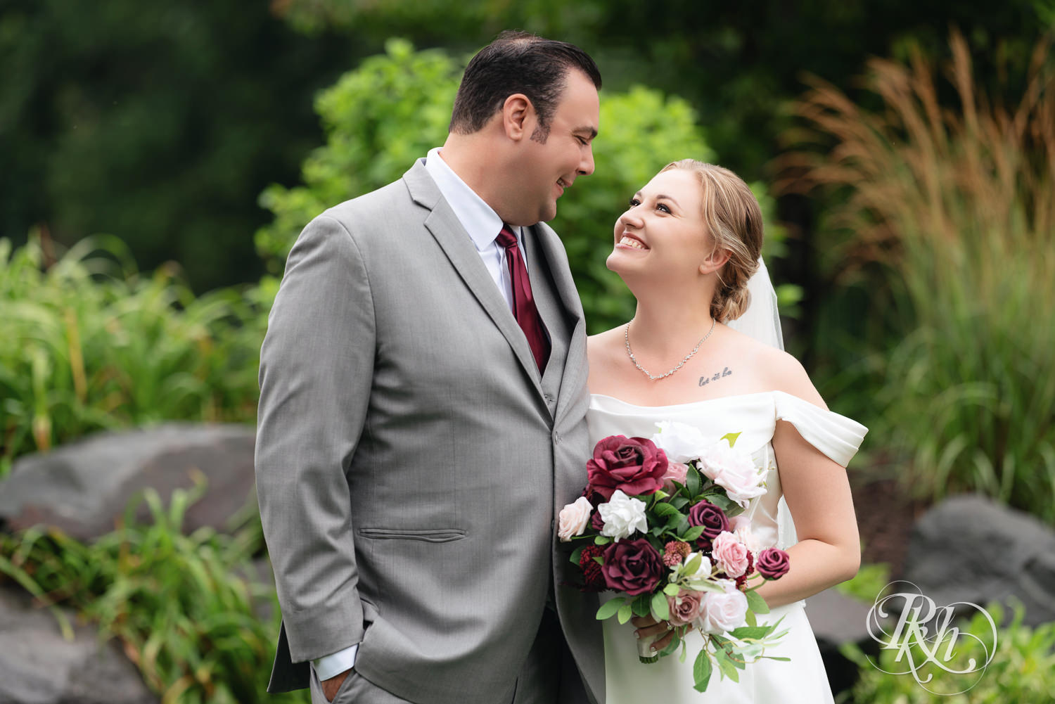 Bride and groom smile on wedding day at Dellwood Country Club in Dellwood, Minnesota.