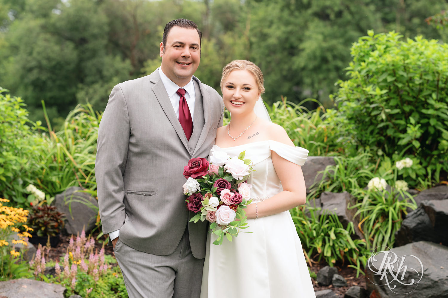 Bride and groom smile on wedding day at Dellwood Country Club in Dellwood, Minnesota.