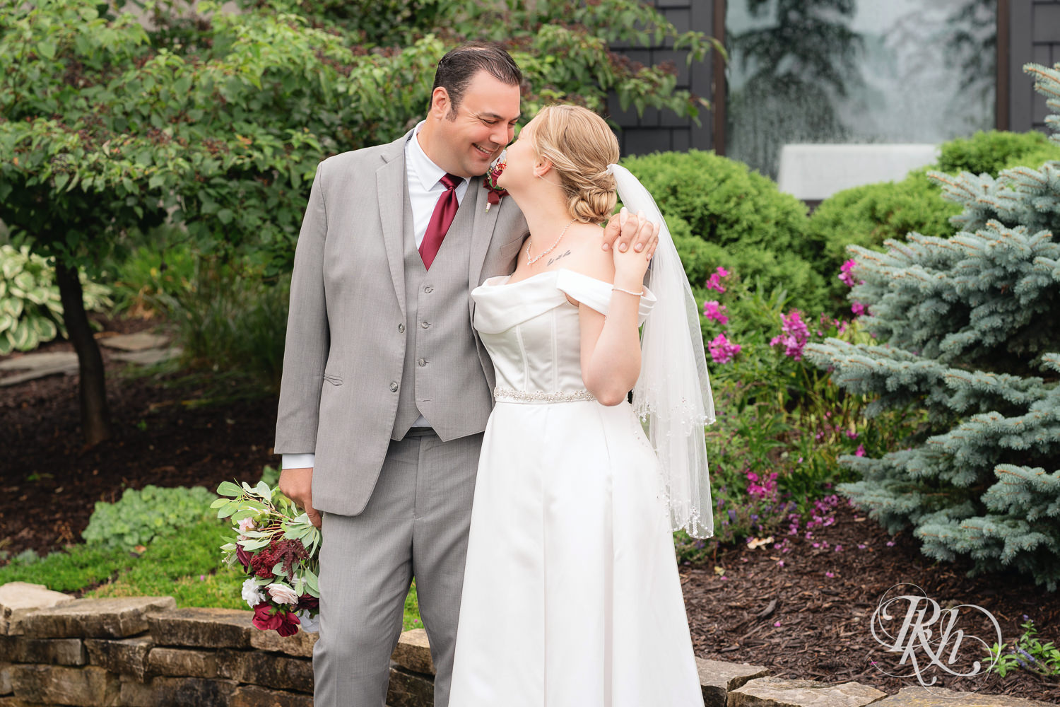 Bride and groom smile on wedding day at Dellwood Country Club in Dellwood, Minnesota.