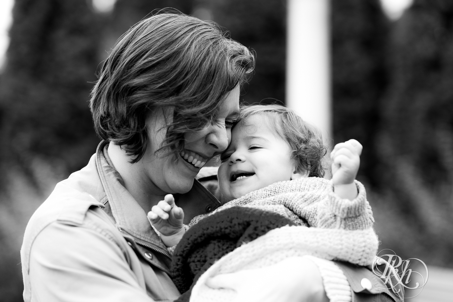 Mom and little girl laugh at Como Park in Saint Paul, Minnesota.