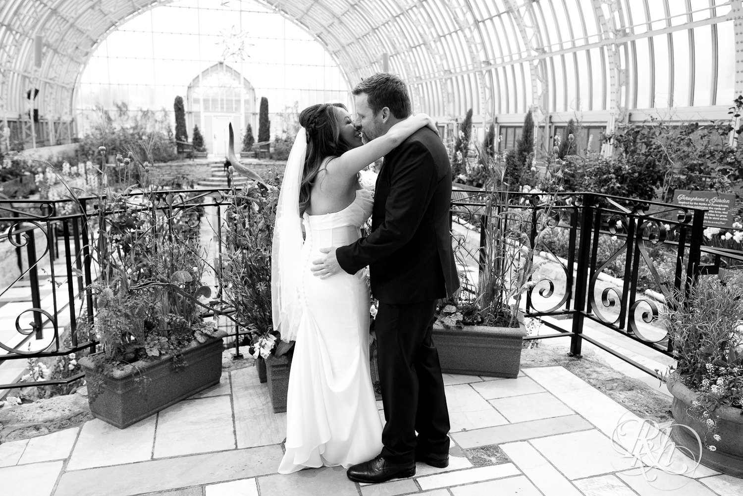 Asian bride and groom share first look on wedding day at the Sunken Garden at the Como Zoo and Conservatory in Saint Paul, Minnesota.