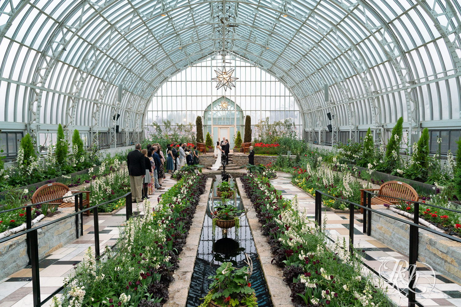 Wide photos of a small wedding ceremony in the Sunken Garden at the Como Zoo and Conservatory in Saint Paul, Minnesota.