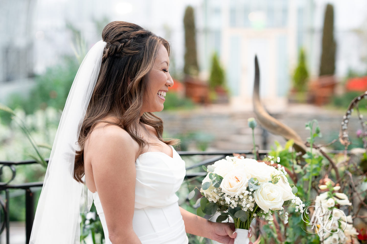 Asian bride and groom share first look on wedding day at the Sunken Garden at the Como Zoo and Conservatory in Saint Paul, Minnesota.